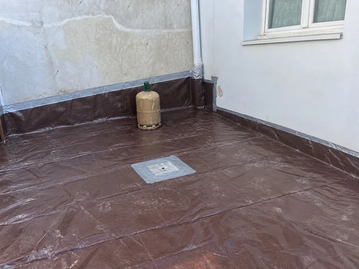 Protection provisoire posée sur un toit terrasse après une fuite, Paris 7e