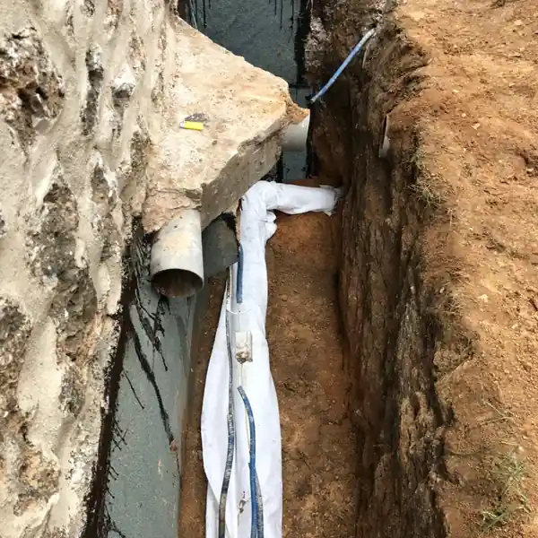 Drain périphérique raccordé aux eaux pluviales au pied d'un mur enterré à Nanterre
